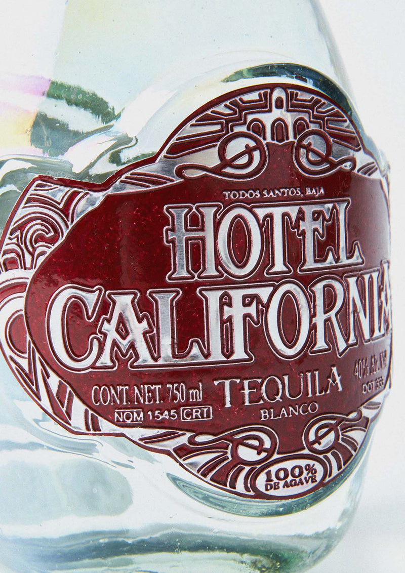 Bottle of Hotel California Blanco Tequila. A premium, craft tequila honoring generations of tequila making tradition, the land from which it comes and the community of artists and craftsman that make it. 100 percent Blue Weber Agave. Jalisco, Mexico 
